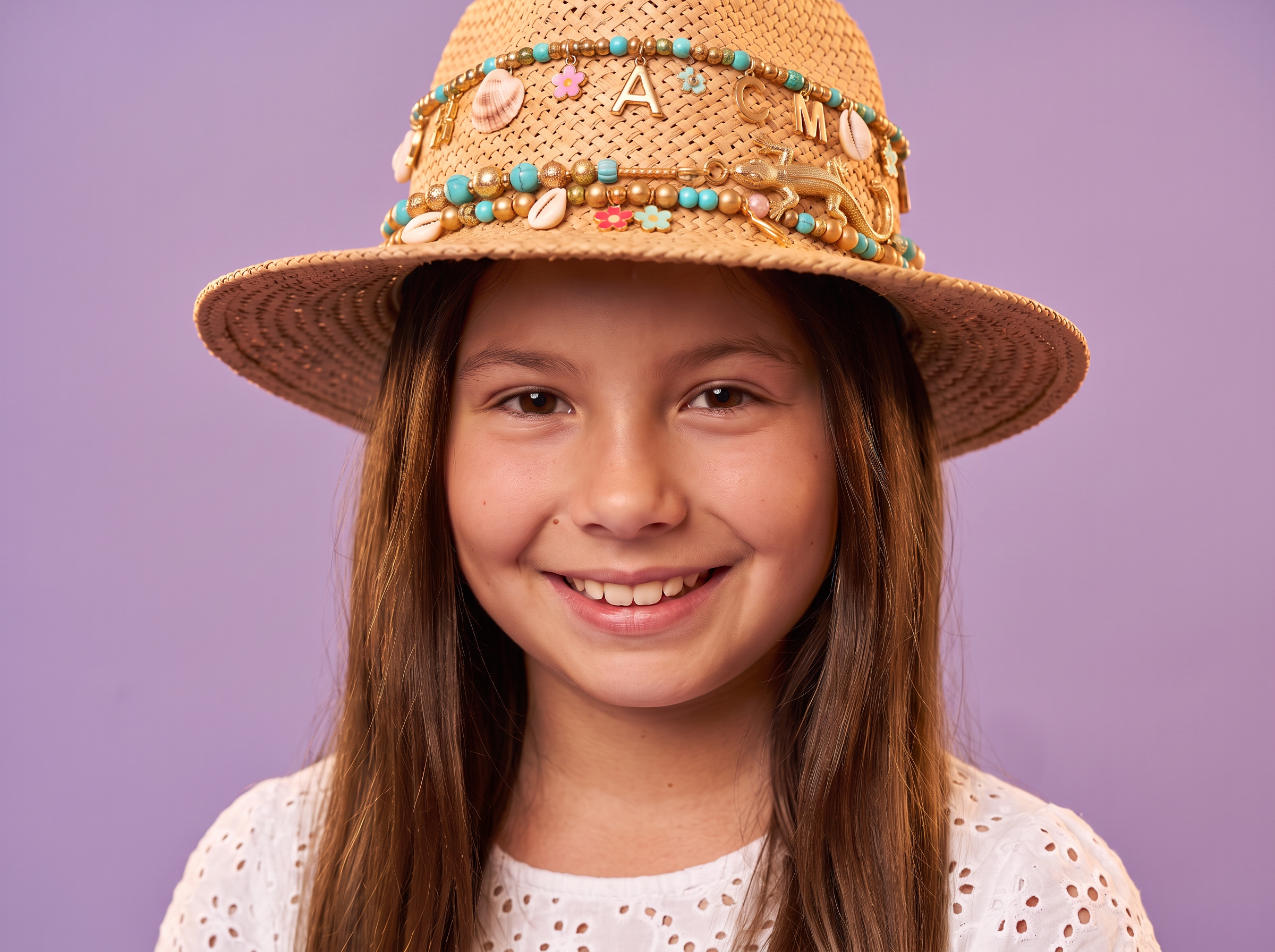 Francesca wearing the Charm Party hat loaded with gold, turquoise, shell and reptile charms