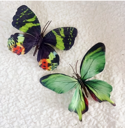 Two feathered butterfly charms in green, black and orange