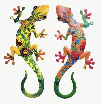Two brightly painted floral gecko charms in yellow and orange
